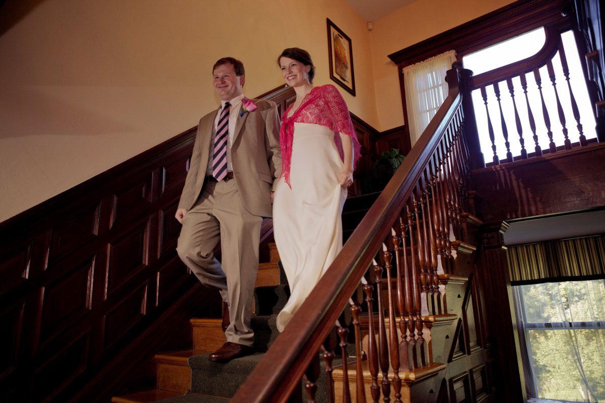 Classic Weddings at Tarrywile couple coming down staircase to reception as man and wife