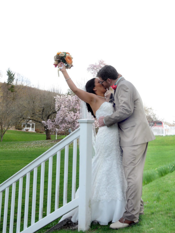 Weddings at Tarrywile bride and groom kissing in front of magnolia tree