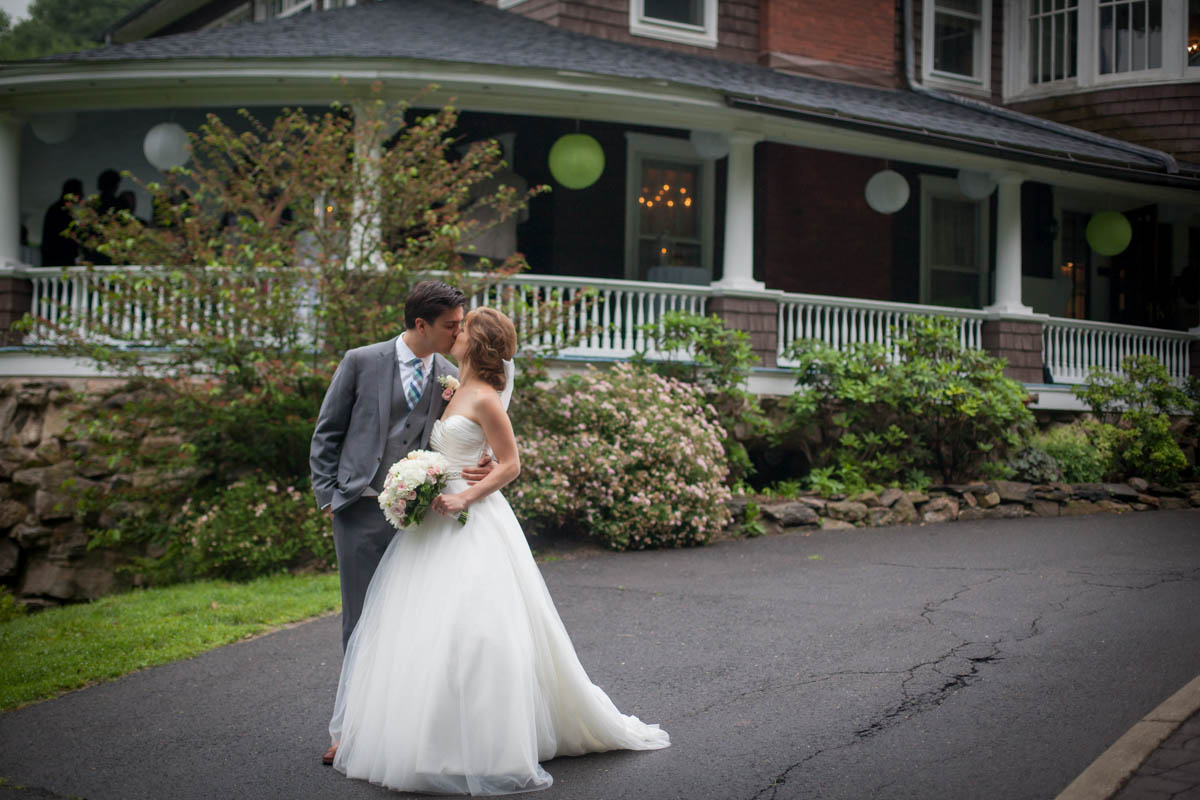 Tent Weddings at Tarrywile high-school-sweethearts-wed-kissing-in-front-of-mansion