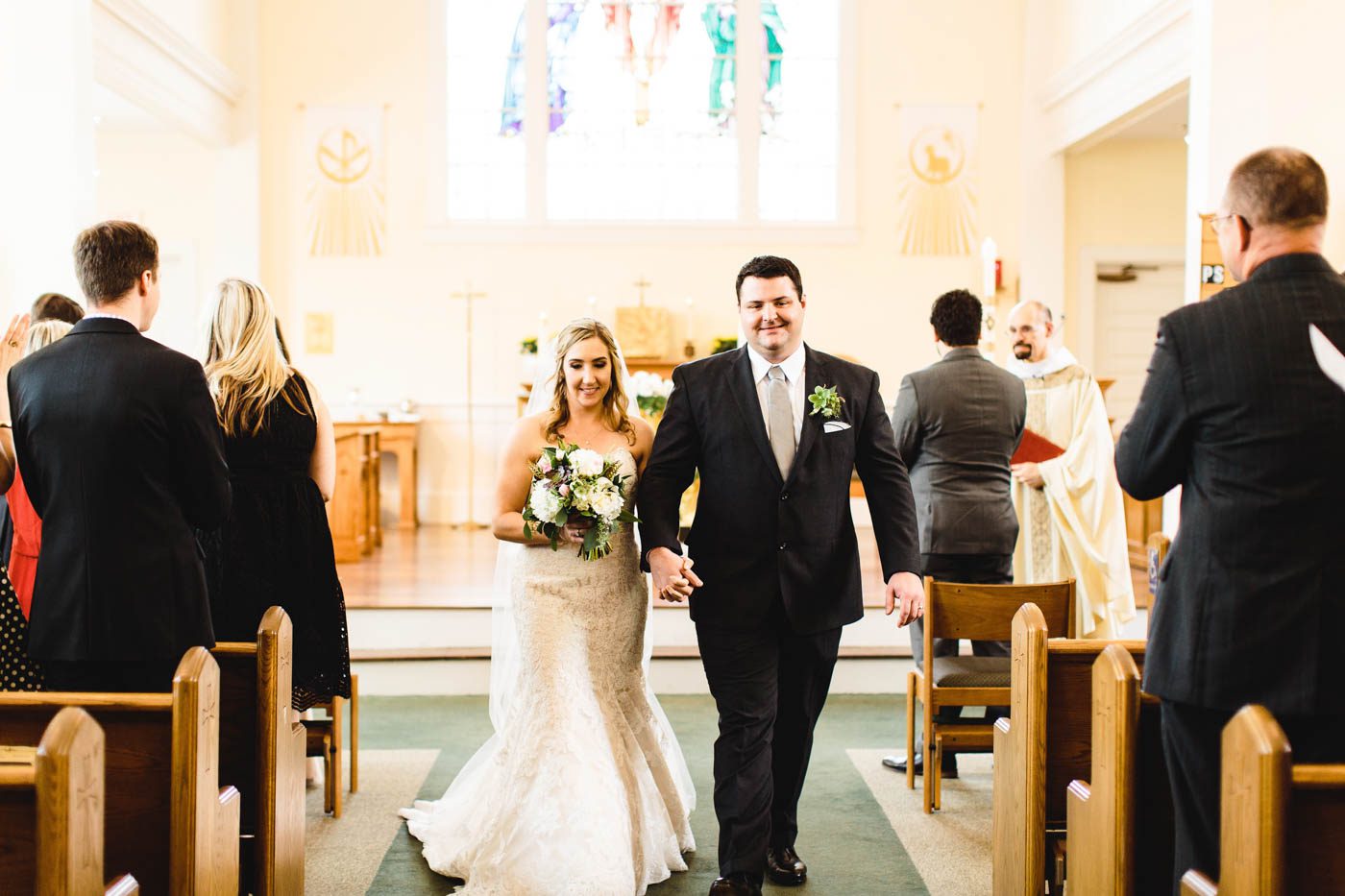 A Church Ceremony for Jenn & Pete church-ceremony-jenn-pete-hand-in-hand-walking-down-the-aisle