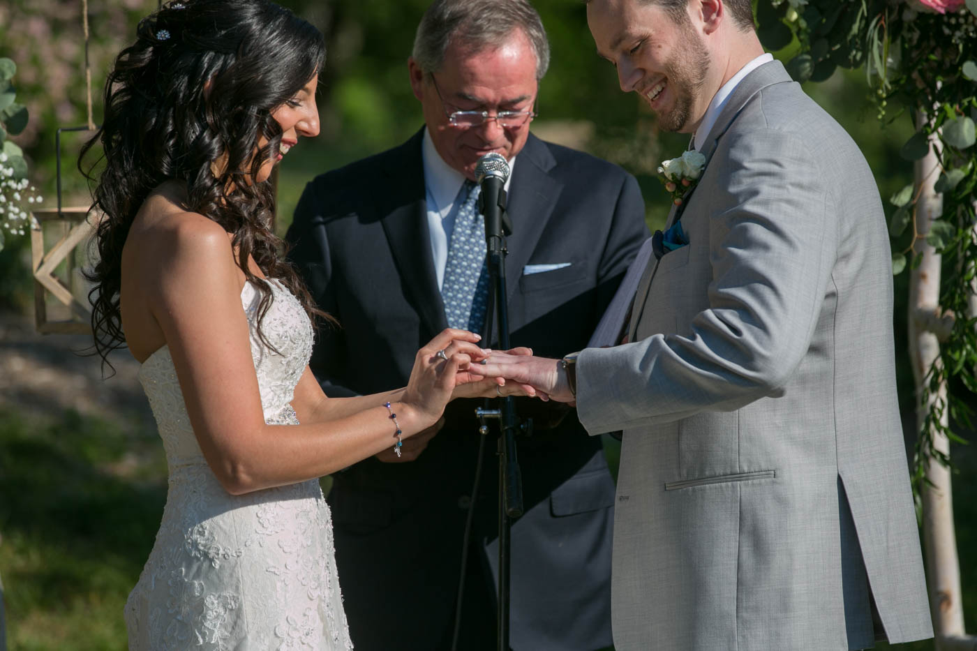 Summer Wedding Ceremony bride-placing-ring-on-grooms-finger-summer-wedding
